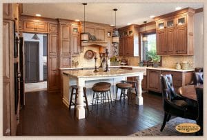 Kitchen design with unique island, hardwood flooring and gorgeous cabinets and backsplash